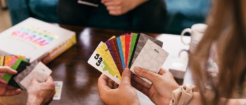 photo d'un groupe de personnes jouant à un jeu de cartes autour d'une table basse